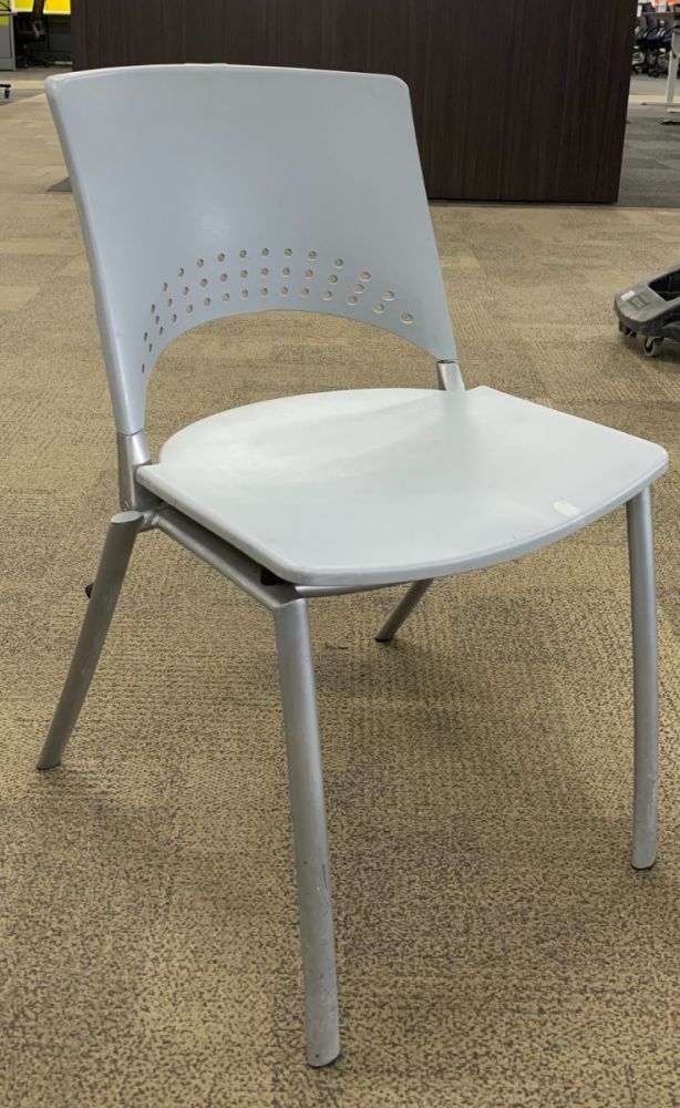 Front view of Pre-owned stack chair has light grey body with perforated back and (4) metallic silver post legs.-B GRADE-