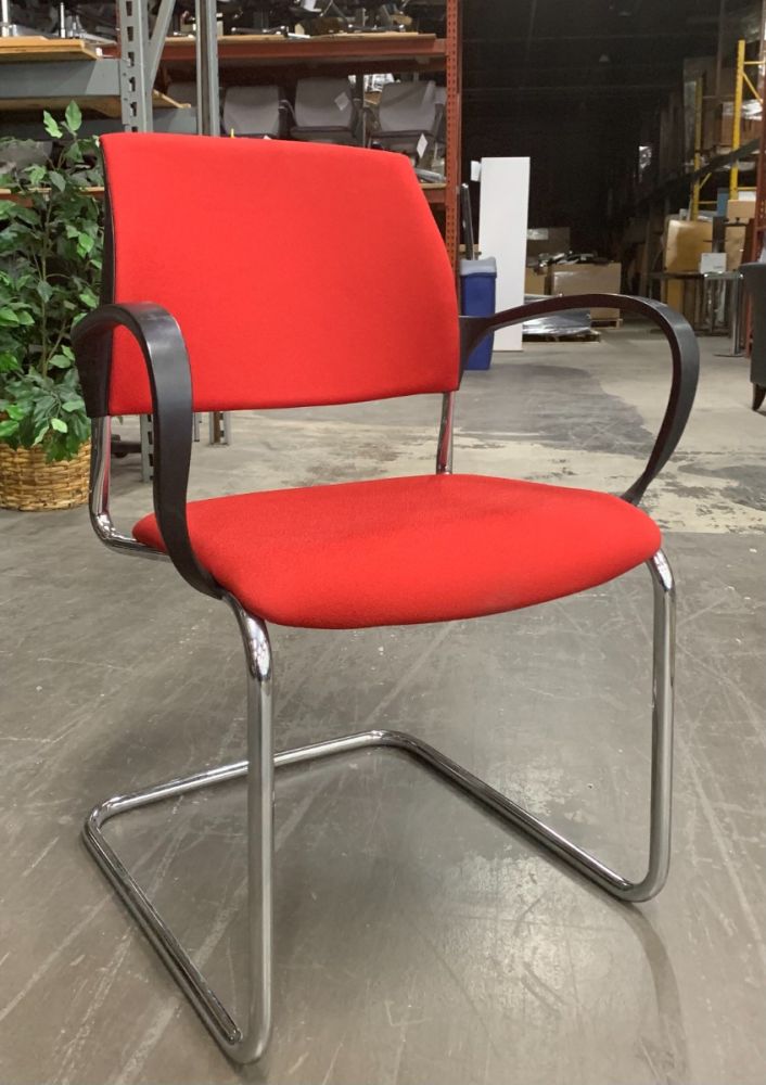 Front view of Pre-owned Drabert side chair has red upholstered body, black loop arms, and (4) chrome post legs. Imported from Germany. -A GRADE-