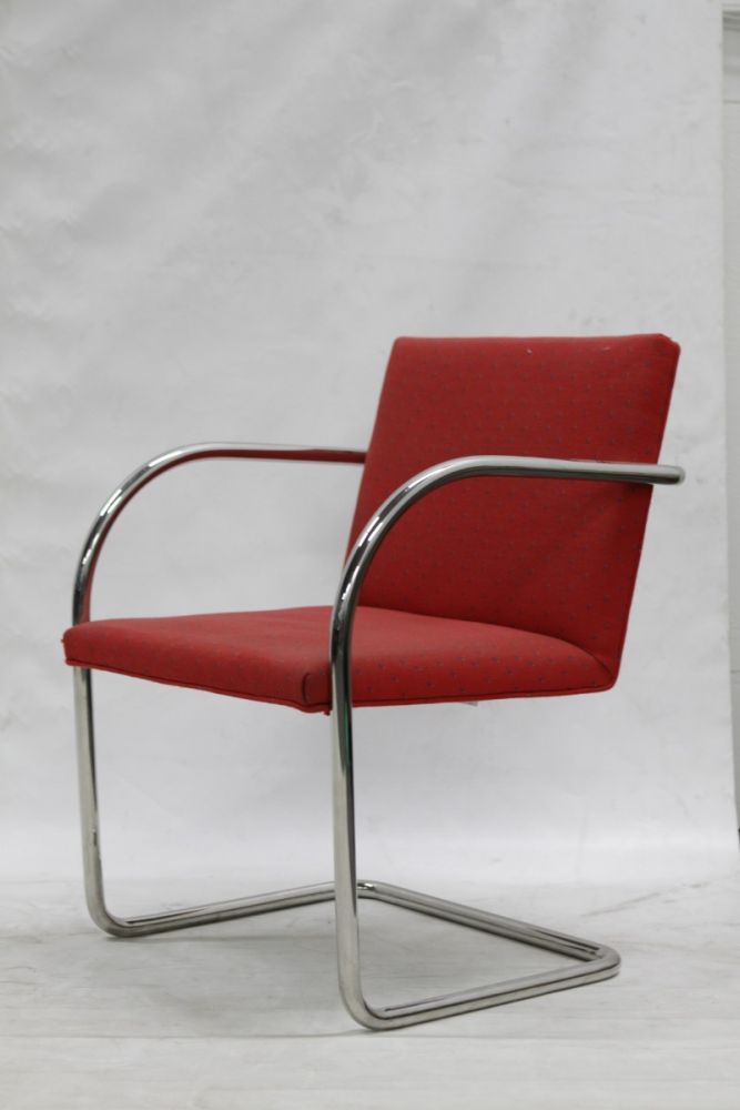 Pre-owned Brueton Brno tubular side chair has a chrome frame. Red upholstery w/ small blue lines in field.